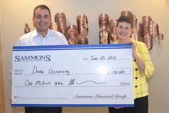 A group photo of Sammons Financial Group employees holding a $1,000,000 check donated to Drake University.