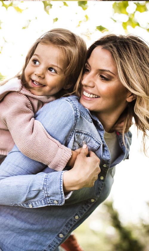 A women carrying a girl on her back