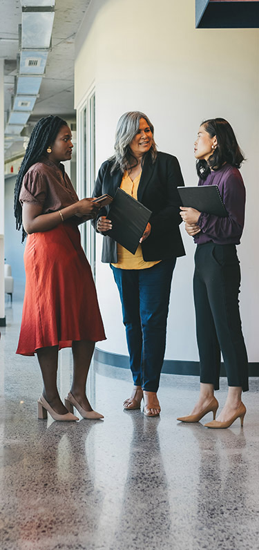 Three women standing and talking