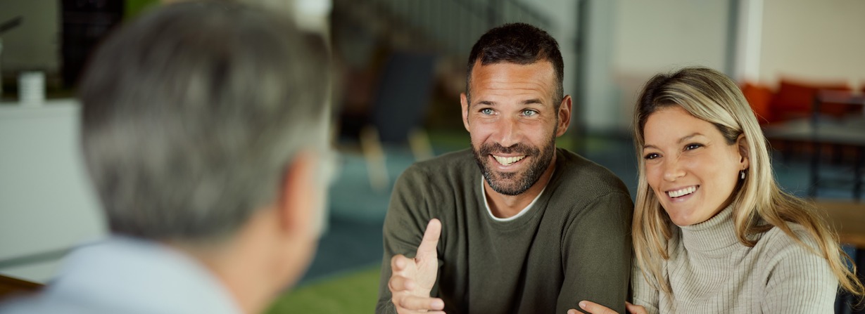 Couple speaking to a life insurance agent