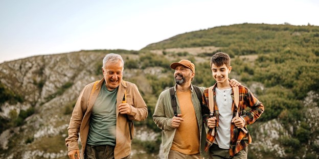 A father, his son, and his grandson hiking together.