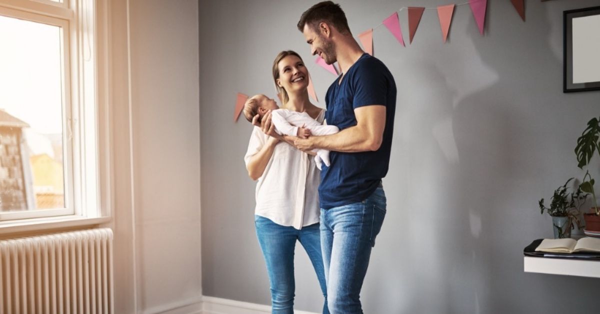 A young mother lets her daughter feel her pregnant belly.