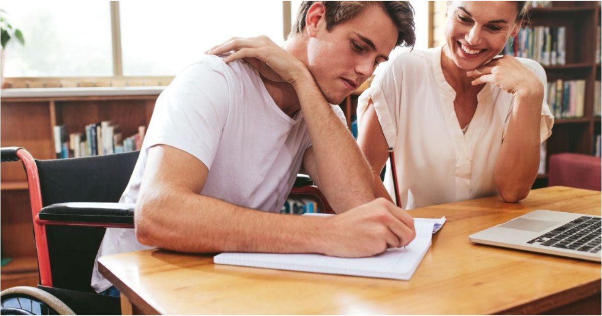 A mother helps her teenage son file his FAFSA.