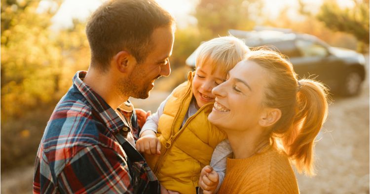 A young family enjoy an autumn day together.