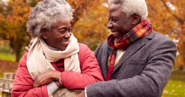 A retired couple enjoy a fall day together.