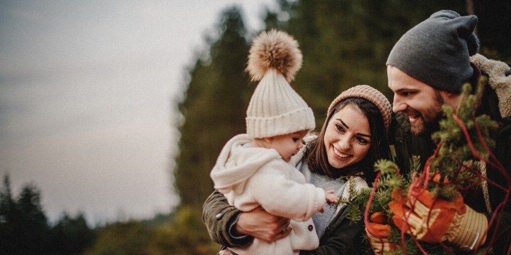 A young family enjoy tree hunting in the outdoors together