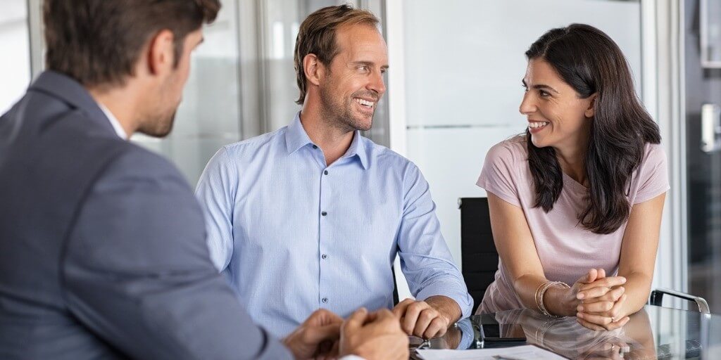 A middle-aged couple meets with their financial advisor