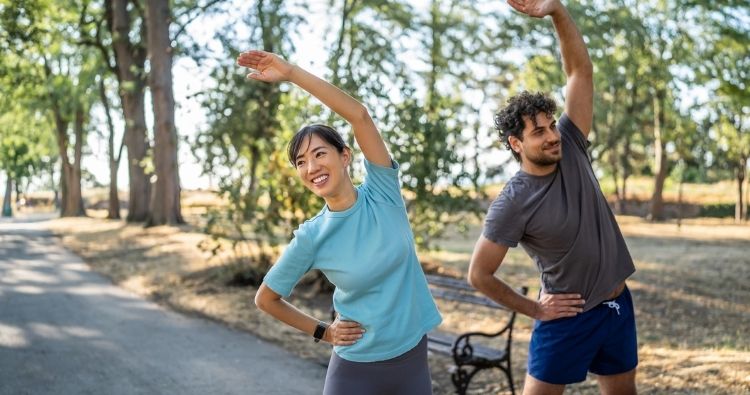 A young couple stretches before they go for a run.