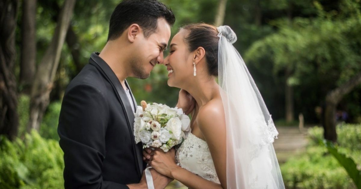 A young couple smile while looking at a engagement ring display