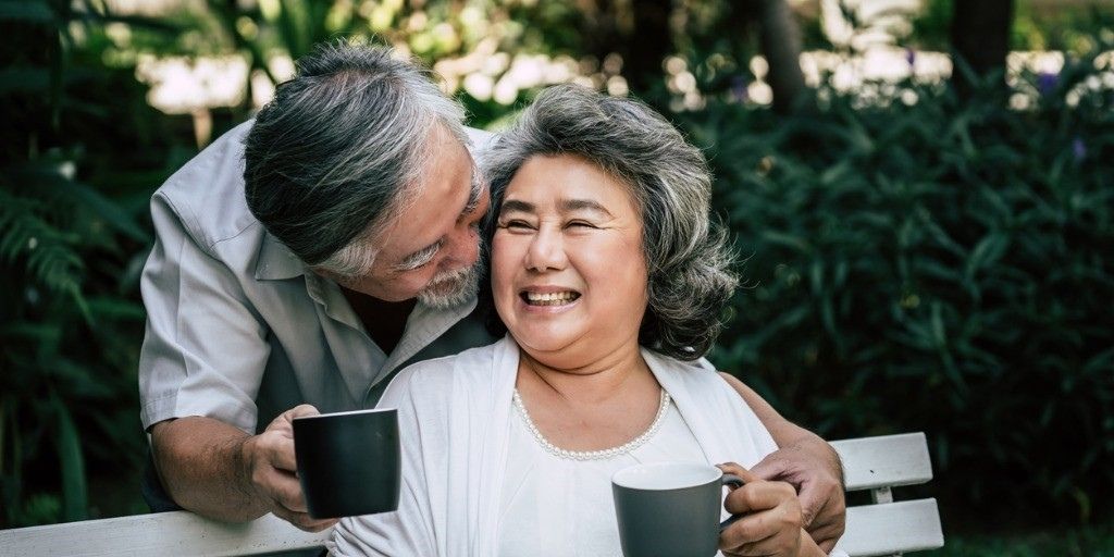An older couple enjoy their retirement together with cups of coffee