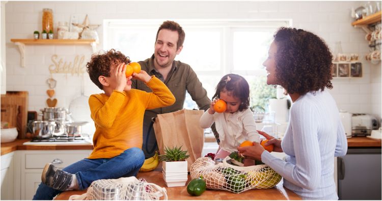 A family having fun while putting away groceries.