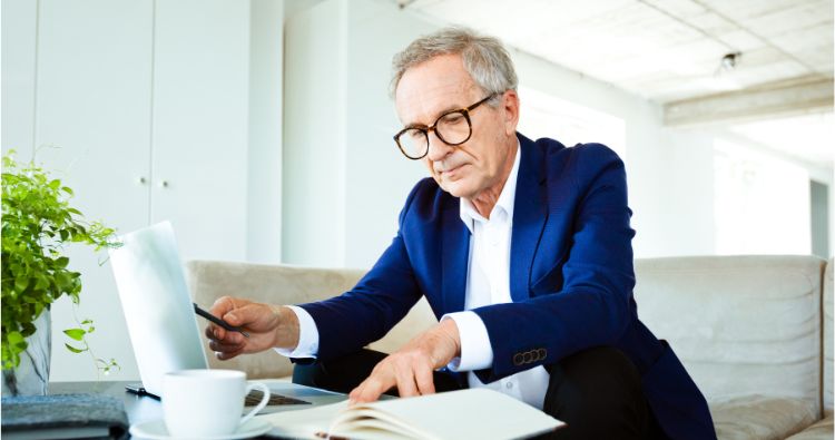 An older man doing his taxes.