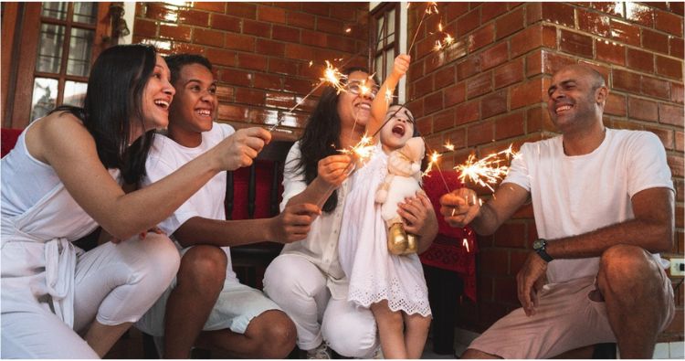 A family celebrate the New Year together with fireworks.