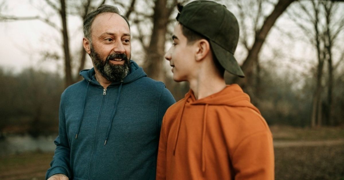 A middle-aged man has a important conversation with his teenage son.