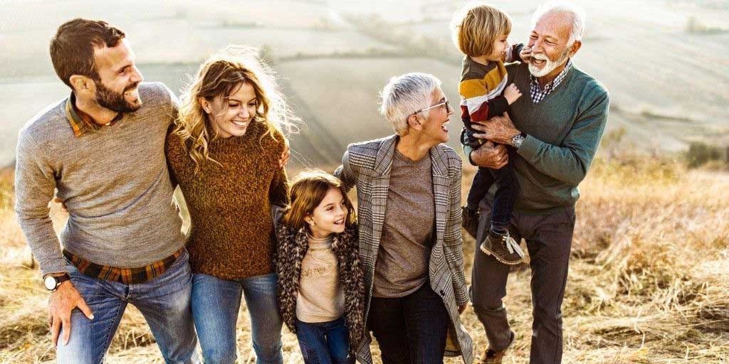 A large family go for a hike in farm lands