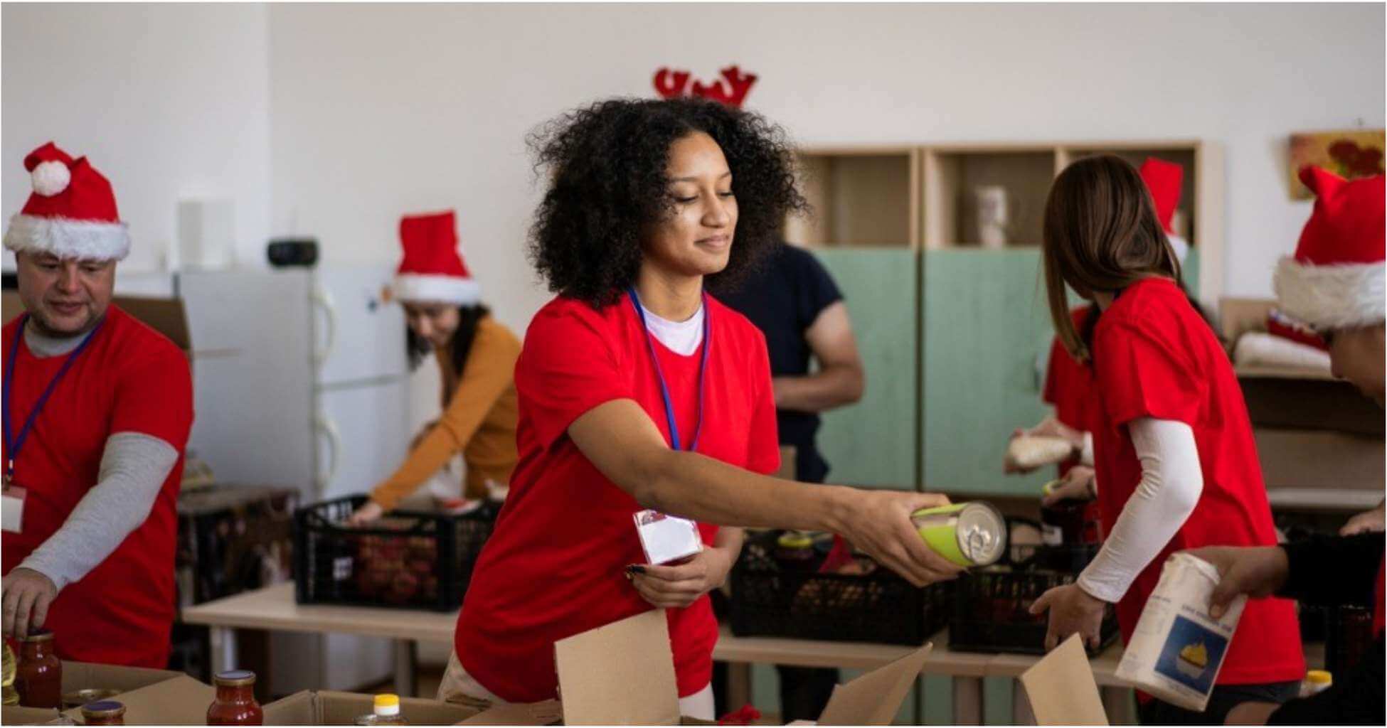 A young woman volunteers by packaging canned goods.